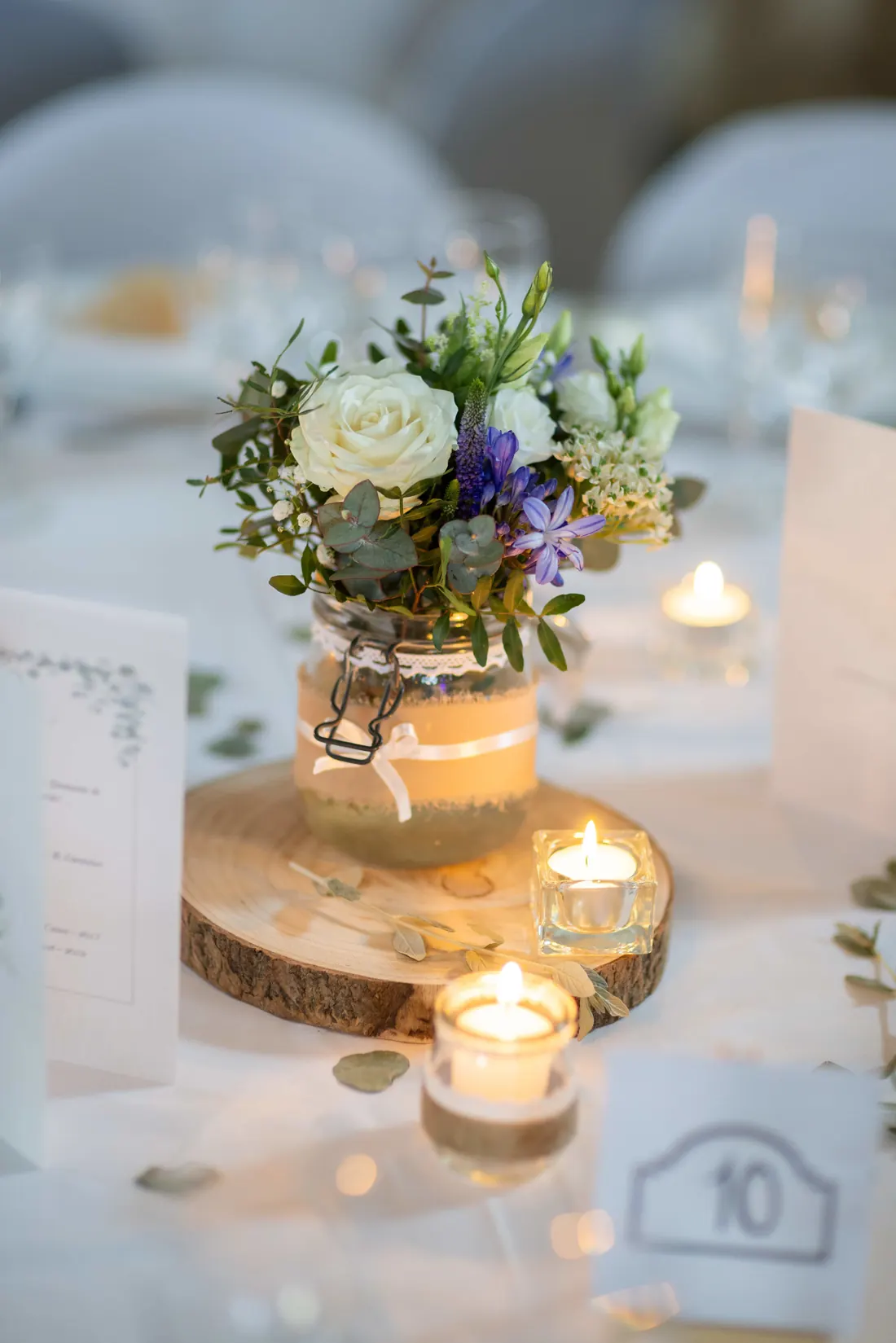 Centre de table de mariage avec bougies et décoration lumineuse.