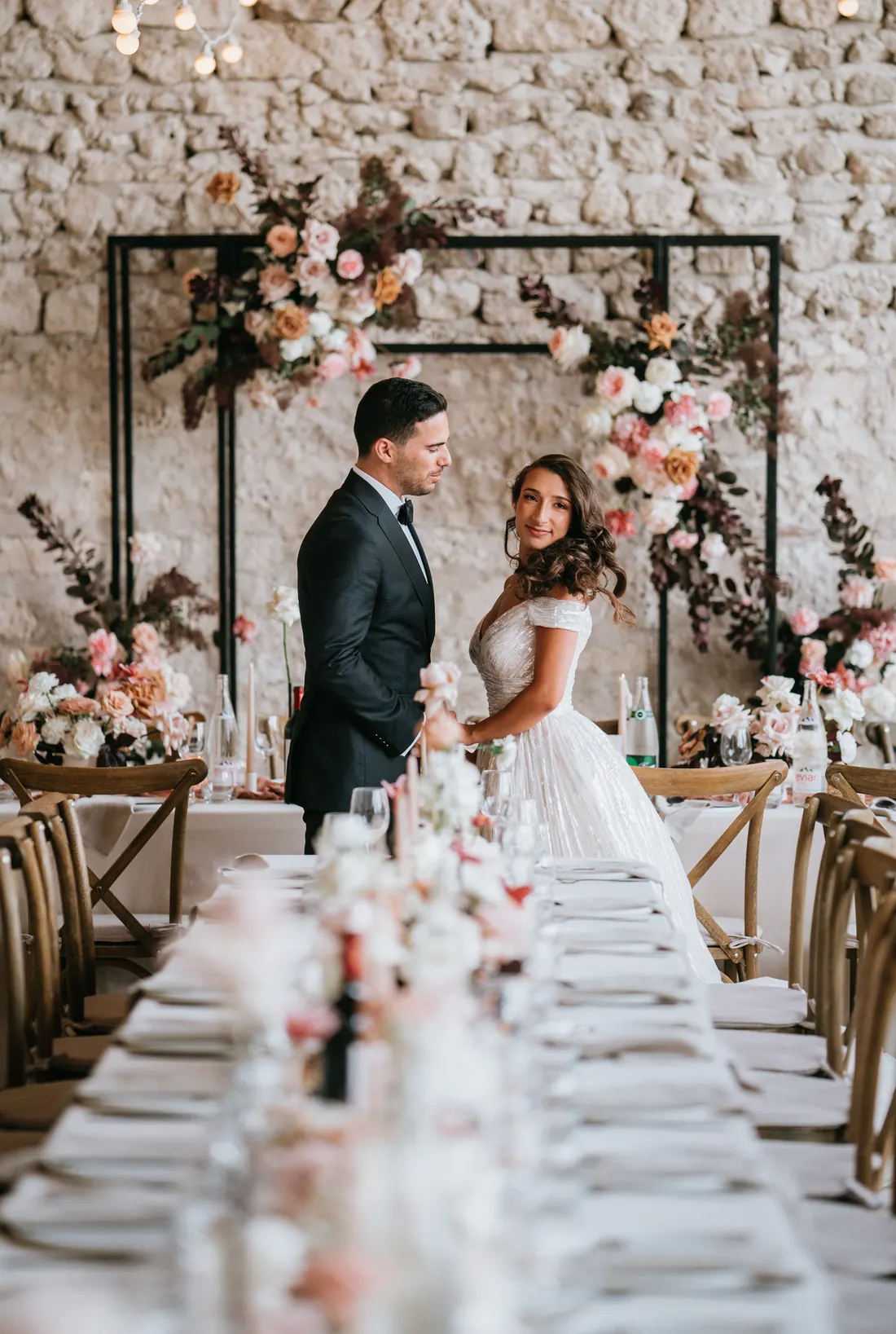 Couple de mariés dans un décor floral romantique.